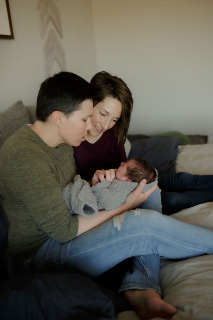 Lesbian couple holding their baby boy